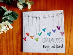 congratulations card with colorful hearts hanging from strings