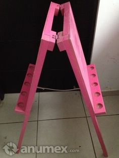 a pink sign sitting on top of a tile floor next to a black and white wall