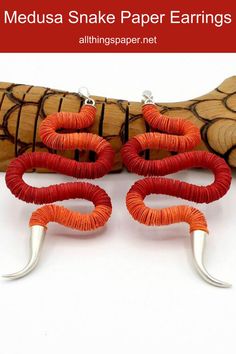 pair of snake-shaped red and orange paper earrings composed of colorful discs displayed on wooden snake. Paper Art Sculpture, Unique Earrings, Sculpture Art, Paper Art, Jewelry Making, Beads