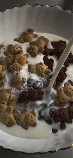 a bowl full of cookies and milk with a spoon in it