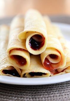 three crepes with jam on them stacked on top of each other