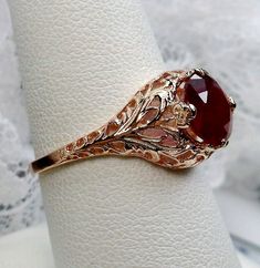 Natural Red Ruby Ring Description  Coffee Design#198 Custom This is a stunning Art Nouveau/Victorian reproduction in 10k rose gold filigree with a 1.84ctw natural red ruby gemstone. The stunning ruby gemstone is 8mm in diameter. The inside of the band is marked 10k for gold. Notice the beautiful craftsmanship of the gold filigree setting and band. This is a ornate and detailed ring. This is a lovely rendition of an antique filigree ring, and it is ready to wear. A gift ring box is included and a Ruby Ring Designs, Leaf Filigree, Red Ruby Ring, Rose Gold Leaf, Mystic Fire Topaz, Antique Style Rings, Swiss Blue Topaz Ring, Natural Ruby Ring, Order Design