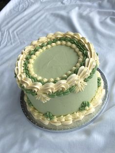 there is a cake with green and white icing on it