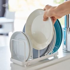 a person placing plates in a dish rack