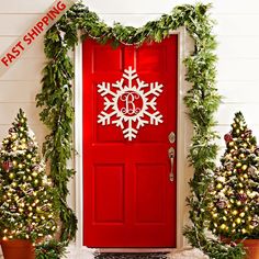 a red door decorated with christmas trees and snowflakes