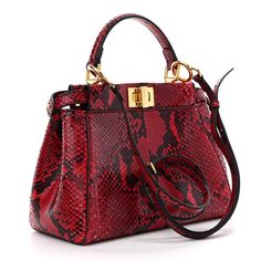 This is an authentic FENDI Snakeskin Shiny Nappa Mini Peekaboo Iconic Satchel. This beautiful handbag tote is crafted of red snakeskin leather. The bag features a leather top handle, a removable shoulder strap, and gold hardware including a gold turn lock. The turnlock opens to a partitioned red leather interior with patch ockets. Fendi Crossbody Bag, Fendi Peekaboo Bag, Pokemon Fabric, Fendi Shoulder Bag, Fendi Peekaboo, Beautiful Handbags, Fendi Bags, Leather Interior, White Bag