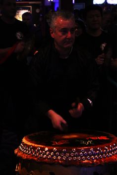 a man standing in front of a large cake