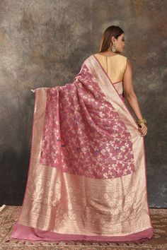 Be vision of elegance on special occasions in this gorgeous onion pink tussar Banarasi saree. It enhanced with floral golden zari jaal and pallu. It comes with a matching blouse piece. Disclaimer: The shown stitched blouse on the model is for display purpose only. The saree comes with a matching blouse piece and finished with fall and piko. The actual product may vary slightly from the image. These are custom orders, hence expect slight variation in color, placement of the motif or buta. ESTIMAT Pink Bollywood Pre-draped Saree With Meenakari, Pink Banarasi Silk Pre-draped Saree, Pink Chanderi Pre-draped Saree With Self Design, Pink Raw Silk Saree With Dupatta, Designer Handloom Pink Lehenga, Designer Pink Handloom Lehenga, Festive Pink Tussar Silk Lehenga, Pink Meenakari Tussar Silk Saree, Pink Tussar Silk Saree With Meenakari