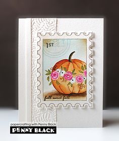 a stamp with a pumpkin and flowers on it's front, sitting on a table