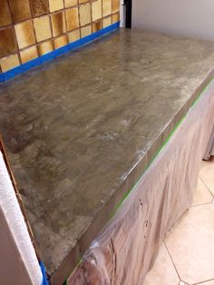 the counter top is covered in plastic and has blue tape on it's edges