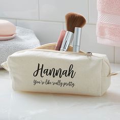 the personalized makeup bag has two brushes in it and is on top of a counter