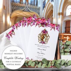 wedding program booklets with pink flowers and greenery in front of an ornate organ