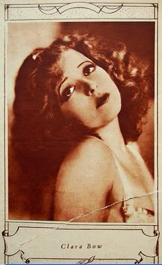 an old photo of a woman with curly hair and big eyes, wearing a bra