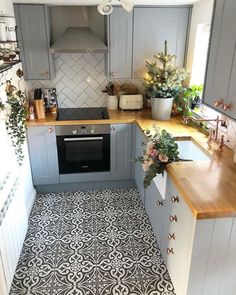 an instagram photo of a kitchen with grey cabinets and wood counter tops on the phone