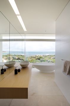 a bathroom with two sinks and a large bathtub