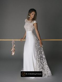 a woman in a white wedding dress holding on to a rail