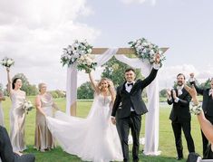 a bride and groom walking down the aisle after their wedding ceremony