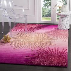 a pink area rug with an abstract design on the top and bottom, in front of a door