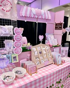 a table with pink and white decorations at a baby's first birthday party,