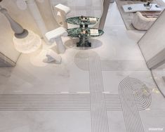 an aerial view of a living room with white furniture and art work on the floor