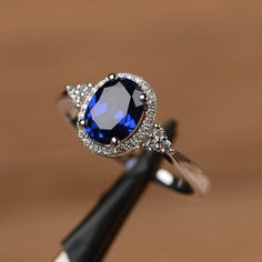 Blue Diamond Rings For Women, Silver Lab-created Sapphire Ring With Halo Design, Oval Sapphire Birthstone Ring In Cubic Zirconia, Silver Oval Sapphire Birthstone Ring, Elegant Silver Birthstone Ring With Lab-created Sapphire, Saphire Engament Ring Set Silver, Blue Sapphire Wedding Ring, Elegant Rings, Oval Sapphire Ring