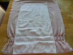 a white towel sitting on top of a wooden table