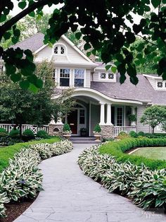 a house that is surrounded by bushes and trees