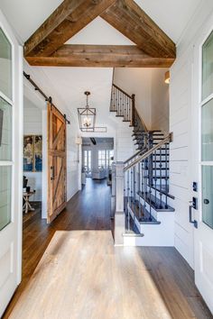 an open floor plan with wood floors and stairs leading to the upper level bedroom area