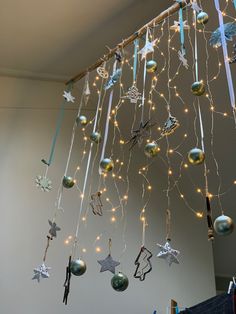 christmas decorations hanging from the ceiling in a room