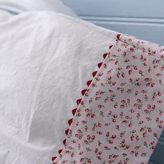 a white sheet with red flowers on it