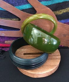 These bangles have one thing in common:  they are all green!  Otherwise, they are as different and ducks and dogs! There is a light green, a medium green, and a dark green bangle. The light green bangle is 10mm wide and incised all around in an abstract pattern.  The opening is 60mm in diameter.  This bangle has faded somewhat over time but there are remnants of the original green on the outside and it is clearly visible on the inside. The medium bangle is my favorite!  It is 28mm wide and the opening is 60mm in diameter.  This bangle is extremely translucent and light shines through it when caught the right way.  While photographing this one, I was able to see my fingers through the bangle when I was holding it. The dark green bangle has a graduated beehive finish and is fully opaque.  It Adjustable Round Green Cuff Bracelet, Vintage Green Adjustable Cuff Bracelet, Adjustable Green Vintage Bangle, Vintage Adjustable Green Bangle, Vintage Green Adjustable Bangle, Handmade Green Round Cuff Bracelet, Adjustable Green Bangle, Adjustable Green Round Bangle, Bakelite Bracelets