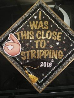 a graduation cap with the words i was this close to striping on it