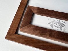 a wooden frame with an image of a monkey on it and the words carved in white ink