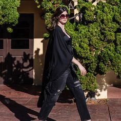 This solid black Kimono Duster Wrap Dress from Jennafer Grace was handmade in San Diego, California from a soft rayon chiffon (Rayon is made from natural wood fibers!). Featuring pockets and a matching waist tie-you can style this piece in at least 10 ways! Machine washable and wrinkle-proof-Perfect for travel, great for bridesmaid gifts!  JG is proud to be a living wage provider in Southern California, and an Earth positive company through the Greenspark coalition.. Bohemian splendor, handmade in California. Machine wash cold and hang dry. Kimono Duster, Black Kimono, San Diego California, Proud To Be, Independent Designers Fashion, How To Feel Beautiful, Waist Tie, Badger, Southern California