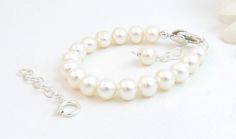 "A classic real freshwater pearl bracelet for newborn, infant, baby, child, or little girl. This bracelet is for her to wear now AND later! It is created with Grade-A 5.5mm round freshwater pearls, a sterling silver heart shaped lobster clasp with an attached 1\" \"Grow with Me\" extender chain, as well as a separate 1.25\" sterling silver chain to attach when she is older. This is a wonderful \"Baby to Bride\" keepsake gift. The pearls are strung on super strong, stainless-steel wire for extra Real Pearl Bracelet, Bride Bracelet, White Pearl Jewelry, Baby Pearls, Initial Earrings, Baby Bracelet, Freshwater Pearl Bracelet, Real Pearls, Sterling Silver Heart