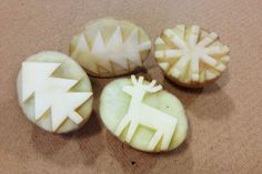 four pieces of carved fruit with designs on them sitting on the floor next to each other