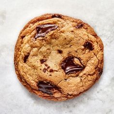 a chocolate chip cookie sitting on top of a table