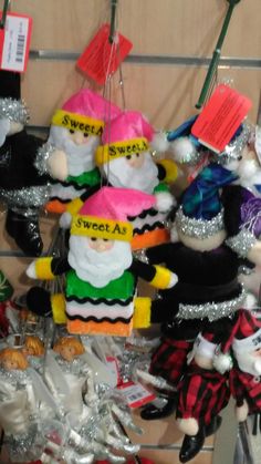 several stuffed toys are on display in a room with tinsel and paper tags hanging from the ceiling