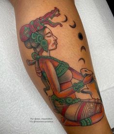 a woman with tattoos on her arm and leg