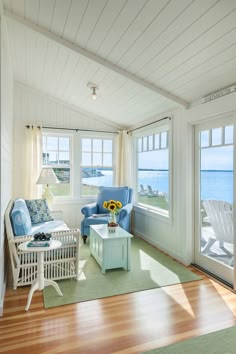 a living room filled with furniture and large windows