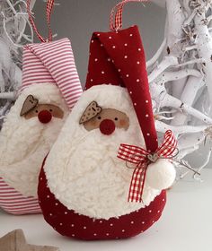 two santa claus ornaments sitting next to each other