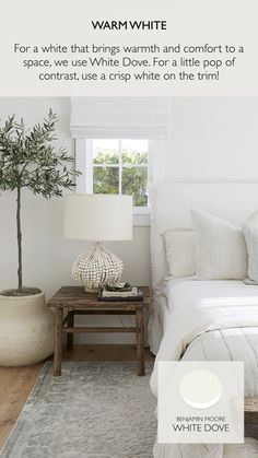 a bedroom with white walls and wood floors