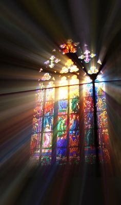 the light is shining through stained glass windows