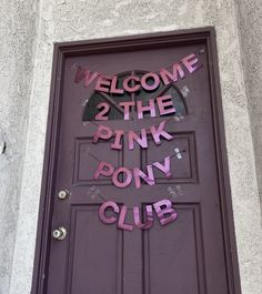 a purple door with the words welcome to the pink pony club on it's side