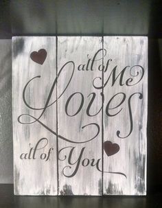 a wooden sign with some hearts on it