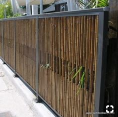 a bamboo fence is next to a building