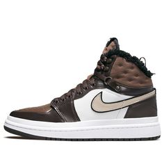 Introducing the Nike Womens Air Jordan 1 Acclimate Chocolate! This sneaker-boot hybrid is perfect for those cold winter days. The upper is made of brown and white leather, with rolled edges and a rubberized heel overlay. The lacing system includes speed hooks and D-ring eyelets. The quilted textile collar and tongue feature a faux fur lining. Above the white rubber midsole is a matching white rubber wrap. The brown cored-out rubber outsole provides grip and durability. Air Jordan 1 Acclimate, Wmns Air Jordan 1, Womens Air Jordans, Jordan 1s, Adidas Spezial, Adidas Campus, Mens Nike Shoes, Nike Air Max Plus, Jordan 1 High