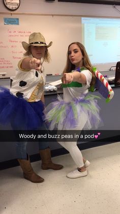 two girls dressed up as woody and buzz in front of a whiteboard with the words woody and buzz pass in a pod