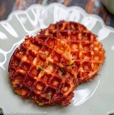 two waffles sitting on top of a white plate next to eachother