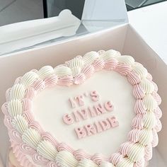 a heart shaped cake with the words it's giving bride written in frosting